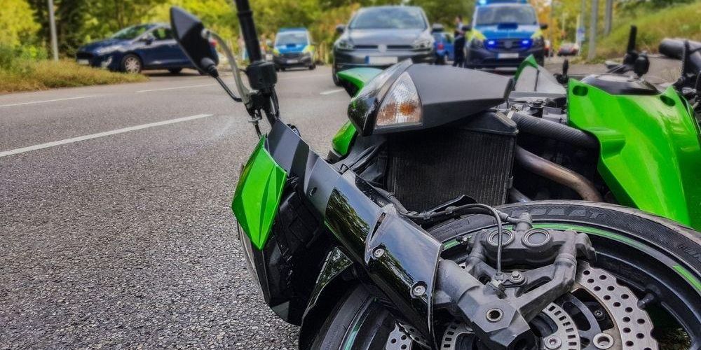 Green motorcycle parked on the side of a