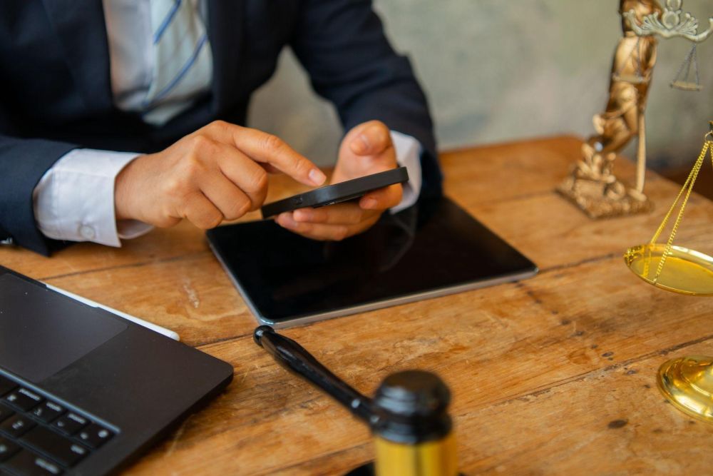 Man reviewing information on a cell phone while sitting at