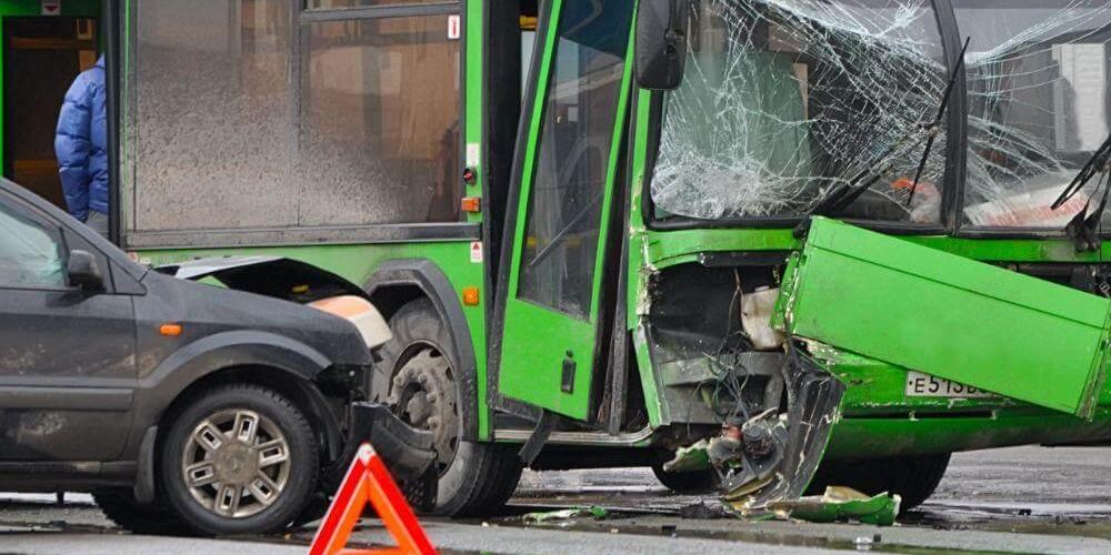 Green bus crash with a car