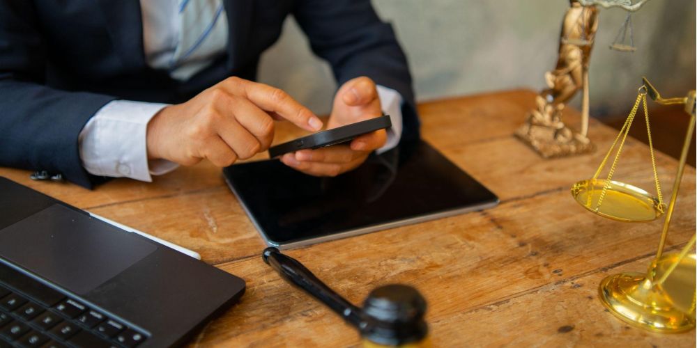 Man reviewing information on a cell phone while sitting at