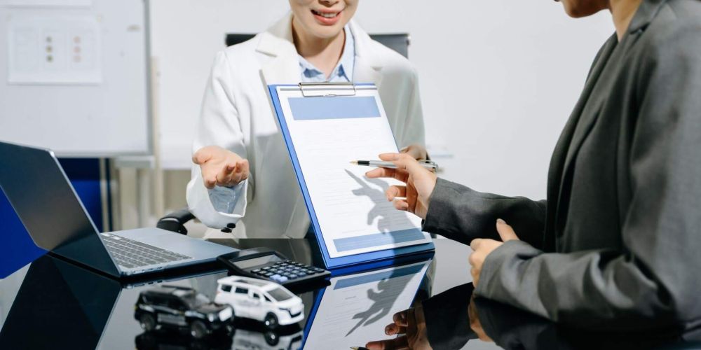 Two women at a desk, likely a lawyer