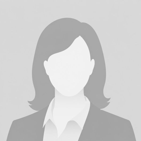 Placeholder silhouette of a businesswoman wearing a suit on a neutral background.