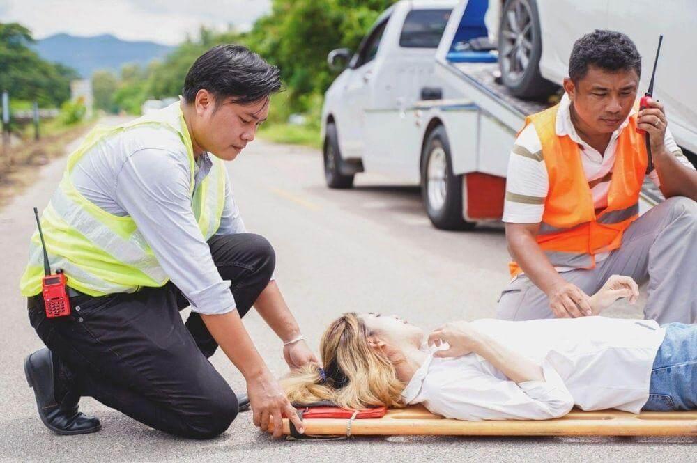Paramedic attending to an injured woman on a